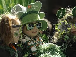 Young girl dressed in St. Patrick's Day attire with green shamrock hat