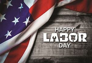 US flag draped across a wooden board with Happy Labor Day 