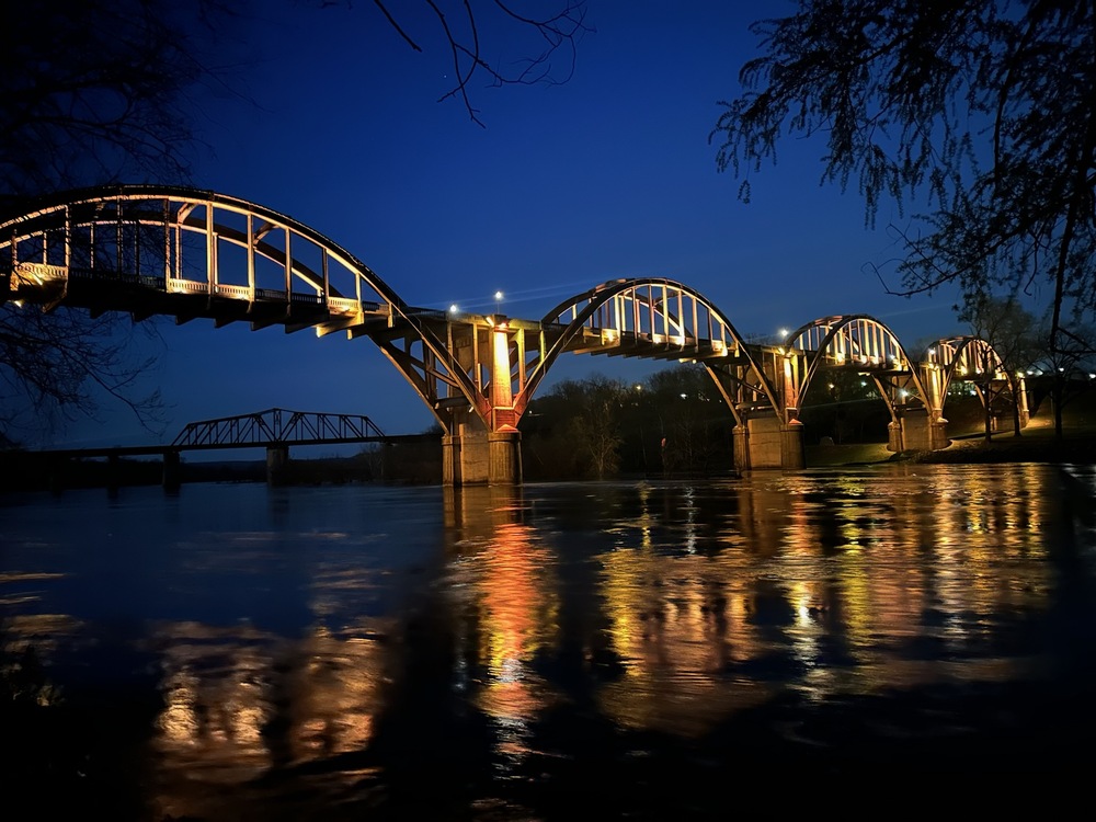 lit bridge over white river