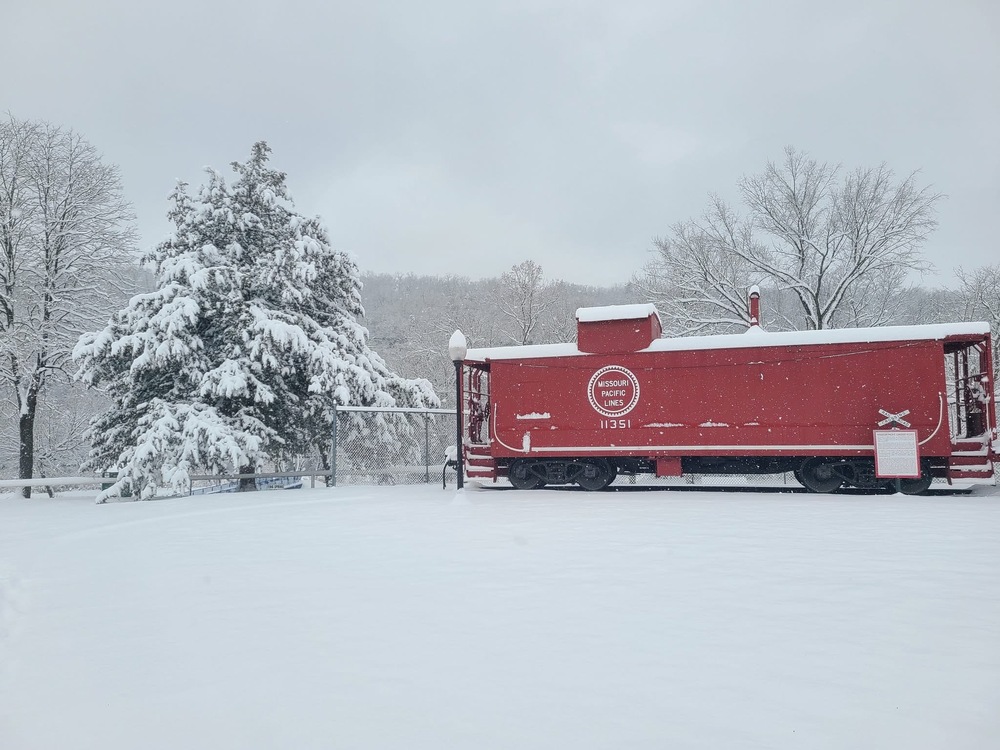 Train caboose in the park covered in snow