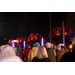 Event goers stand together, taking photos of the bridge as it lights up in different colors.