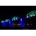 Cotter Bridge illuminated in color at night.