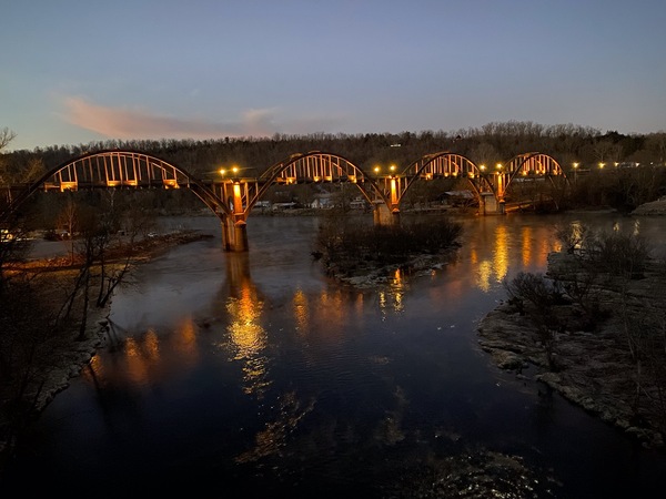 Cotter Bridge lit up in amber tones; the photo was taken by Ray Theobold